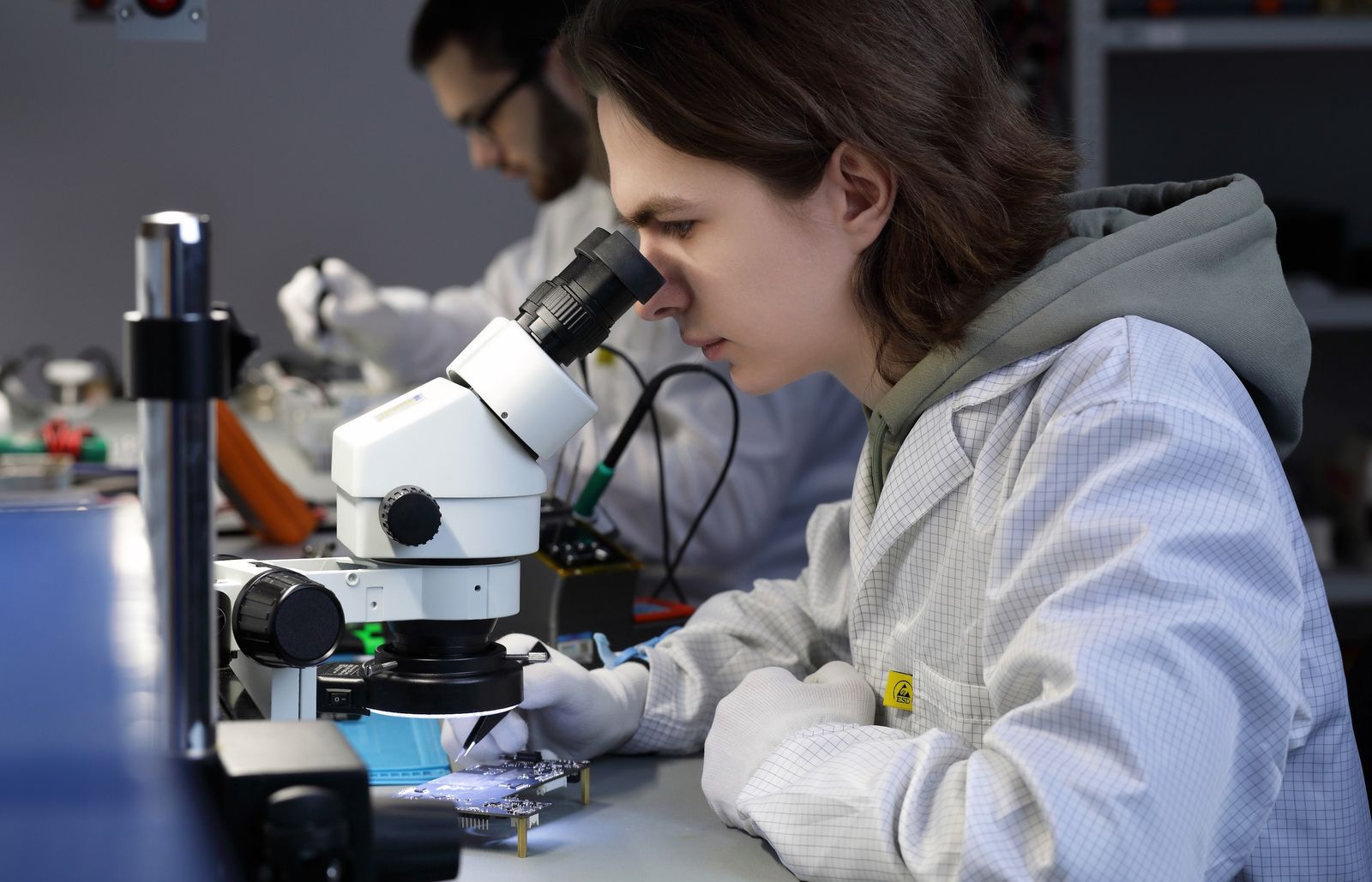 TESART engineer inspecting an RF board under a microscope